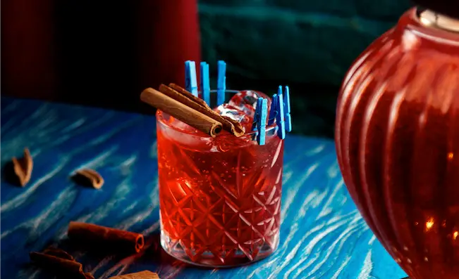 A vibrant cocktail at a burlesque show at Pensão Amor in Lisbon, offering a unique nightlife experience during Shin-Tours Luxury Tours. Immerse yourself in vintage charm, eclectic performances, and expertly crafted cocktails on your luxury adventure.
